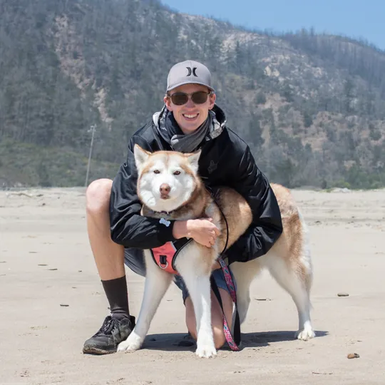 Lars and Lucy the husky on the beach